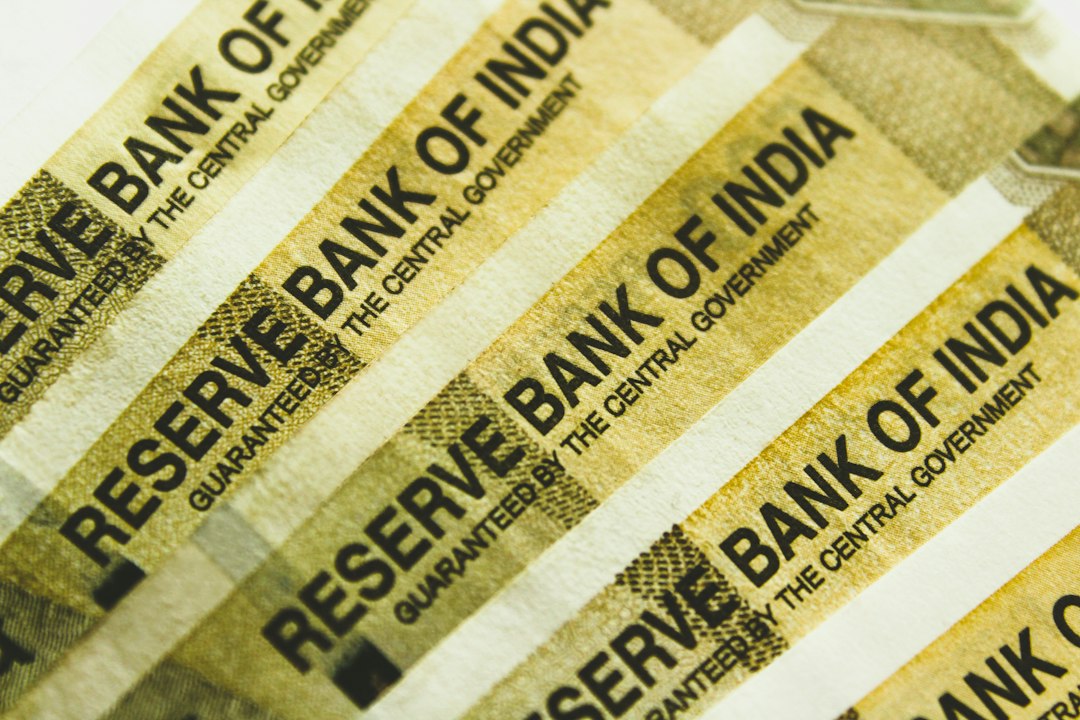 A stack of indian bank notes sitting on top of each other