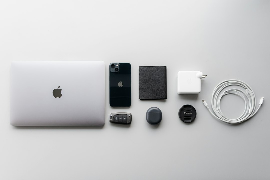 A white apple laptop sitting on top of a table