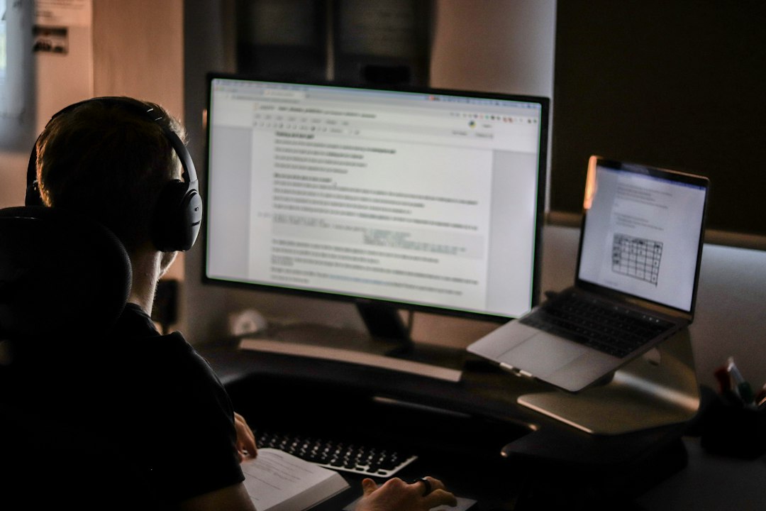 Man using laptop computer and headphones