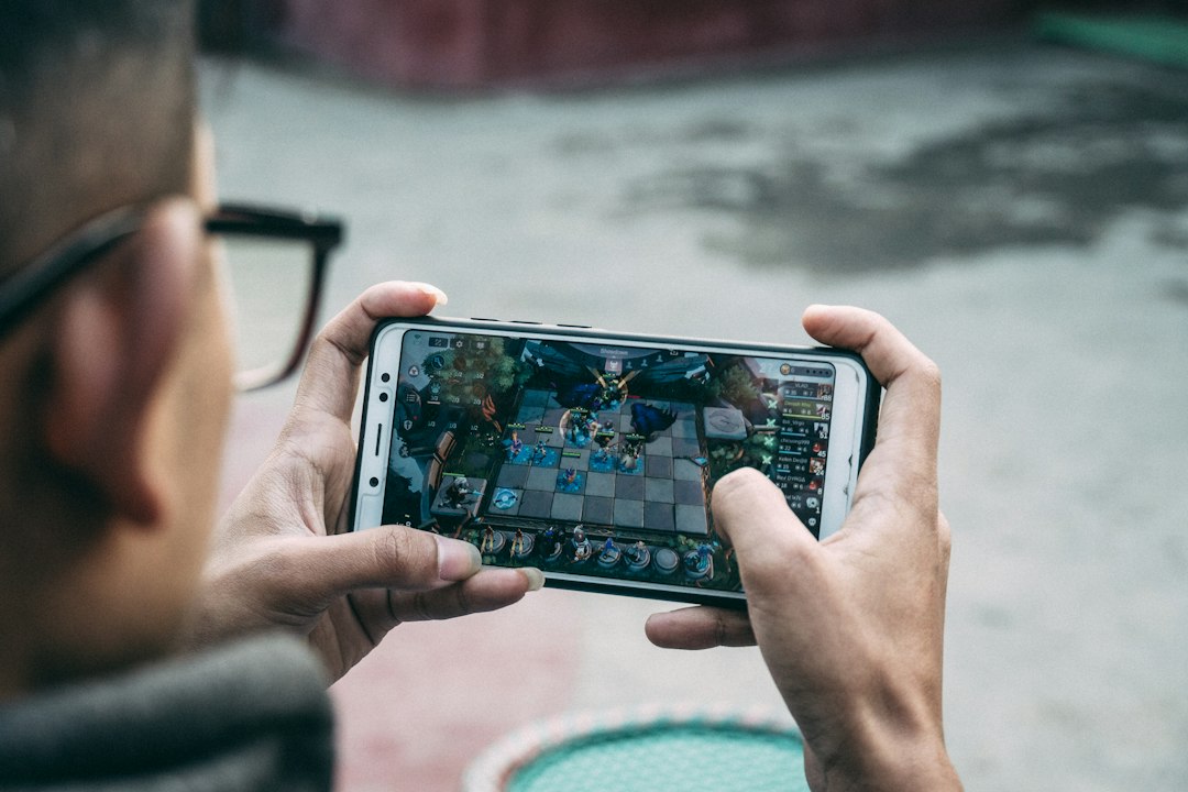 A man is playing a game on his phone
