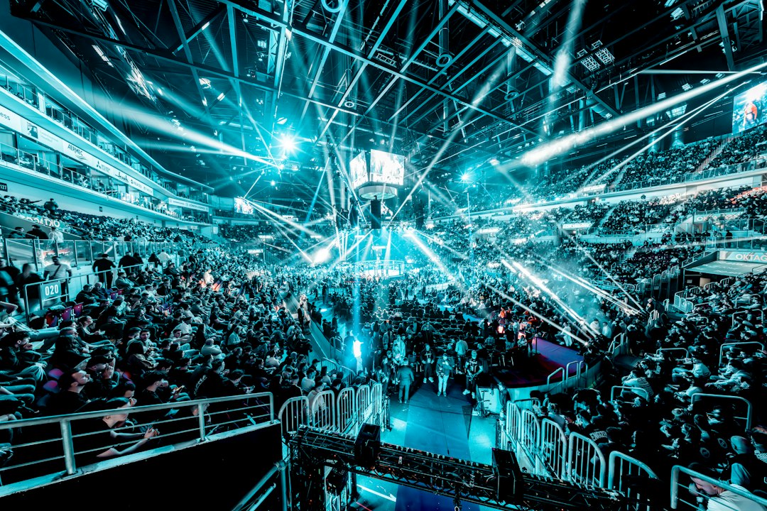 Crowd at a concert with bright blue stage lights