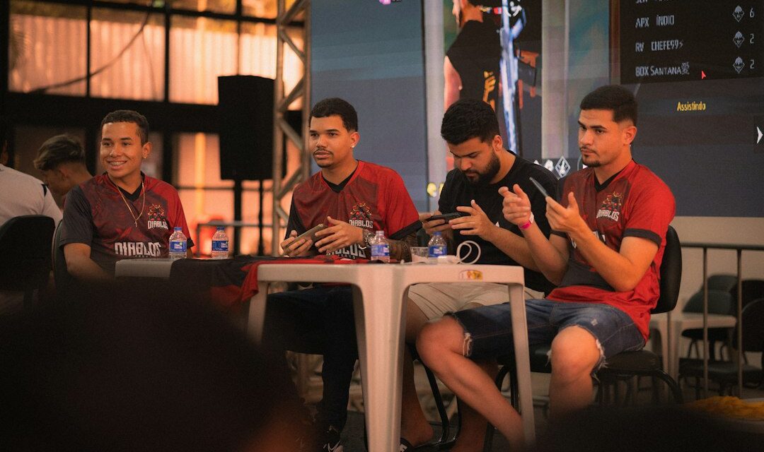 Four men sitting at a table during an event