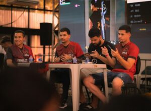 Four men sitting at a table during an event