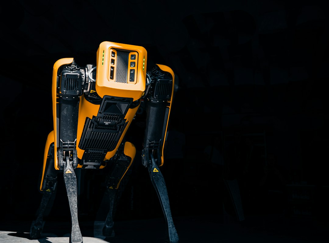 A yellow and black robot standing in the dark