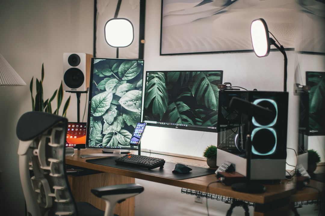 Black flat screen computer monitor on white wooden desk