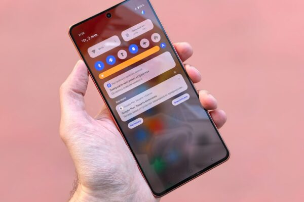 A hand holds a smartphone showing notifications