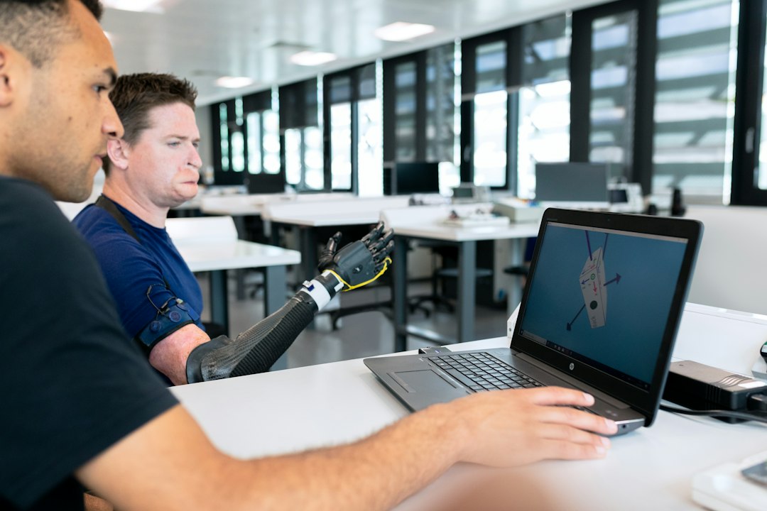 Man in blue crew neck t-shirt using black laptop computer