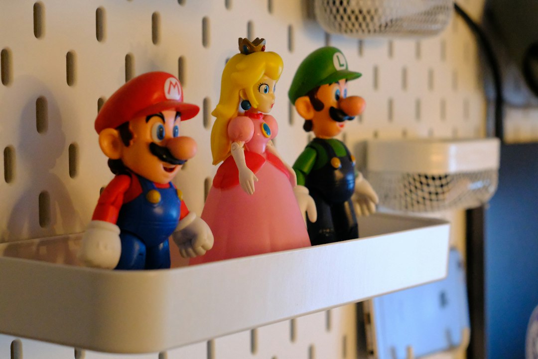 Mario, princess peach, and luigi figures on a white shelf