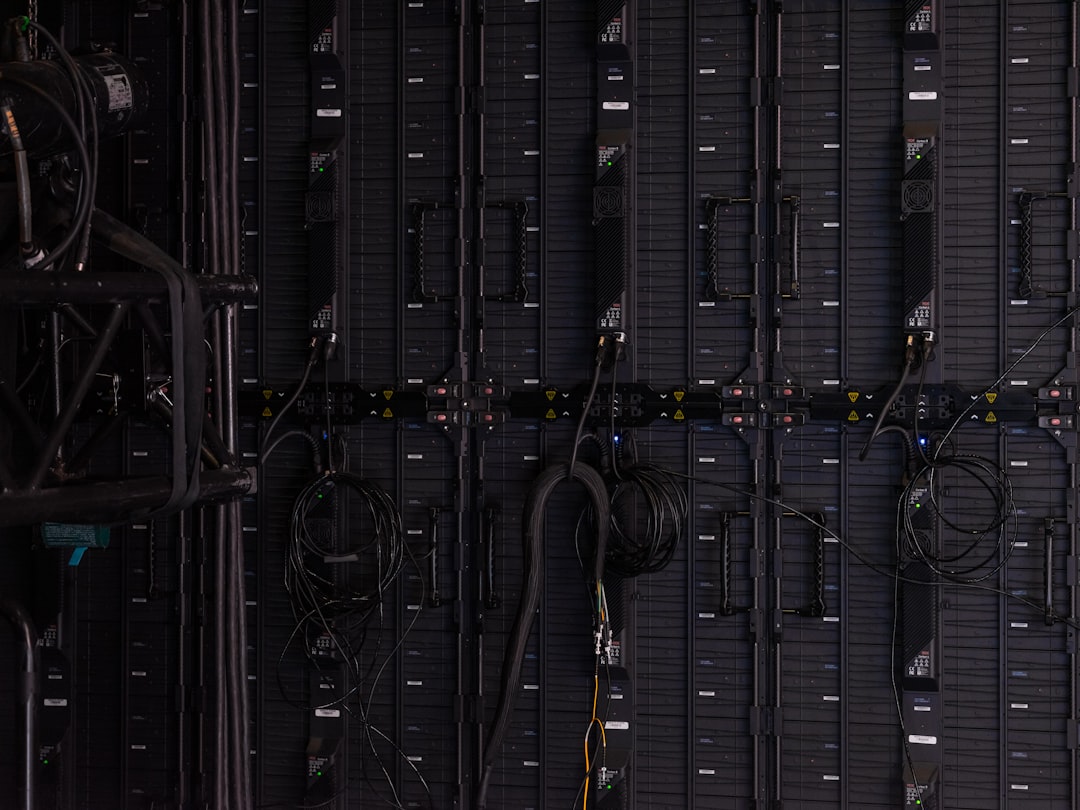 Black cables and wires connected to the back of modular LED display panels
