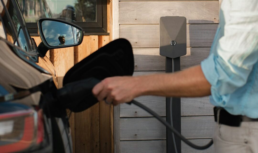 A man pumping gas into his car at a gas station