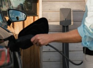 A man pumping gas into his car at a gas station