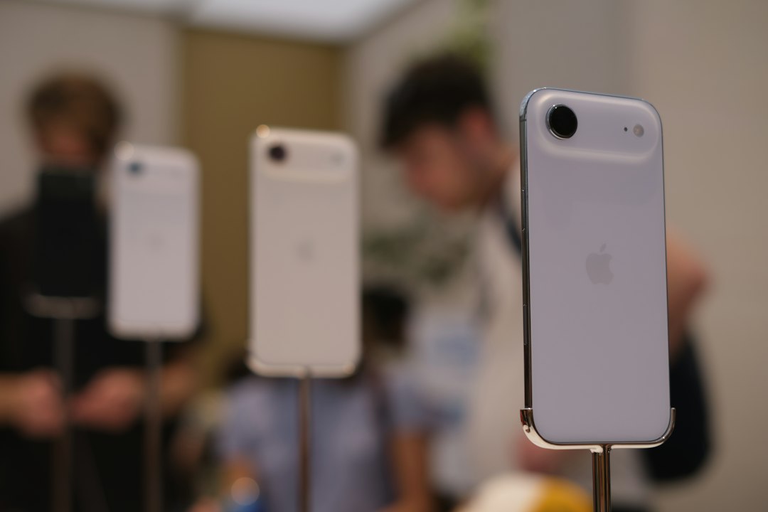 Several white smartphones displayed on stands