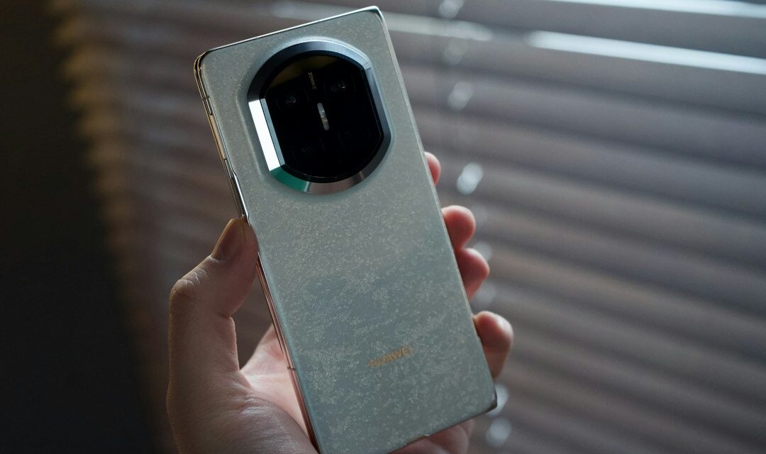 Hand holding a vintage smartphone with a circular camera lens