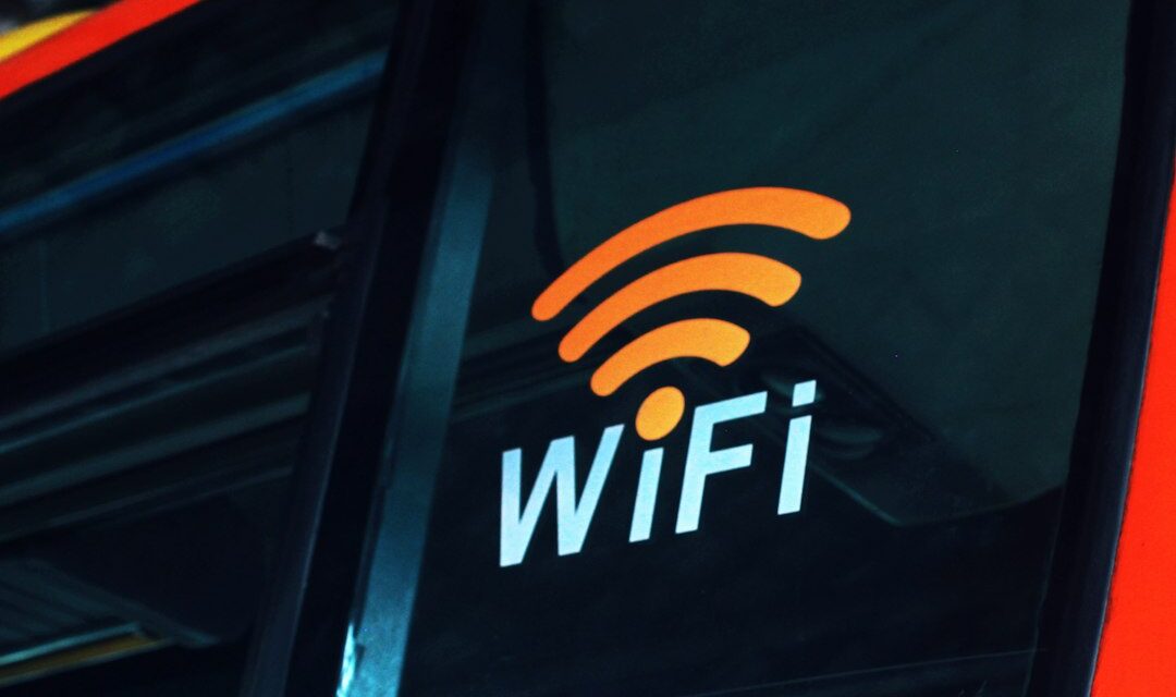 A close up of the wifi logo on the side of a bus