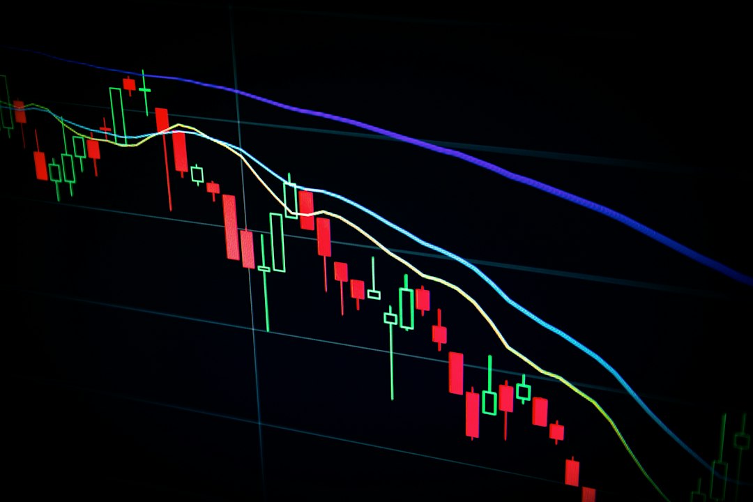Stock market candlestick chart on dark screen