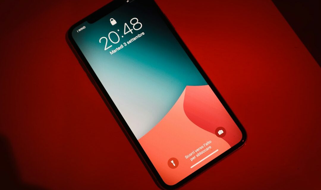 A close up of a cell phone on a red surface