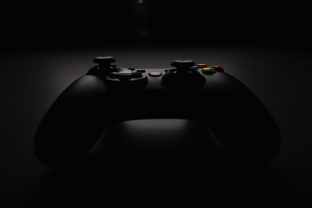 Shallow focus photography of black Xbox controller