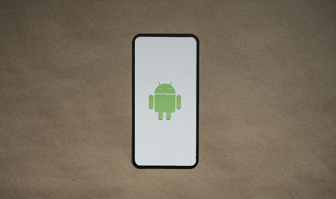 A cell phone with a green icon on it