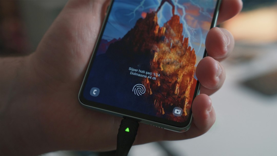 A hand holding a cell phone