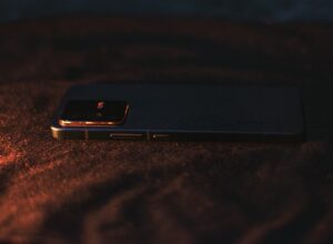 A close up of a cell phone on a bed