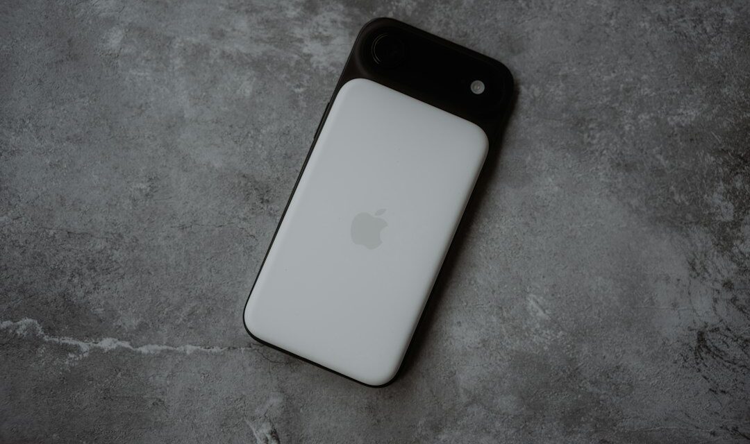White smartphone with black camera lens attachment