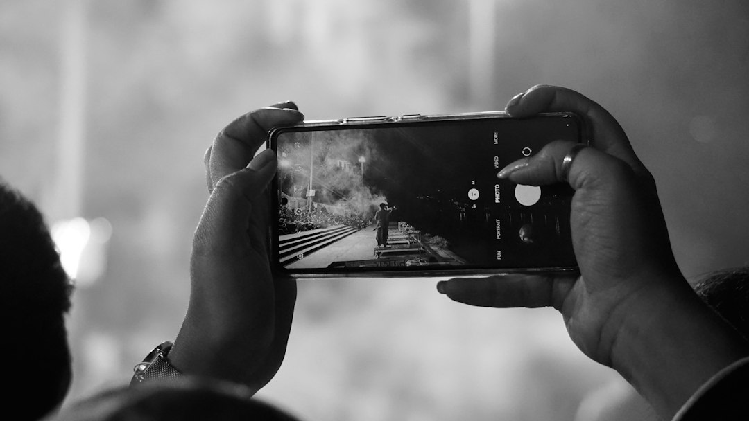 A person taking a picture with a cell phone