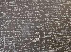 A blackboard with a lot of writing on it