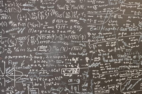 A blackboard with a lot of writing on it
