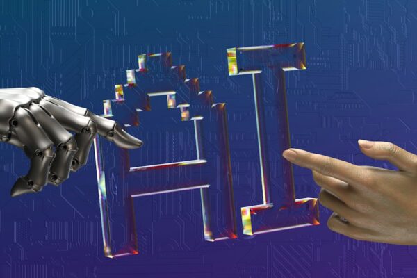 Robot and human hands reaching toward ai text