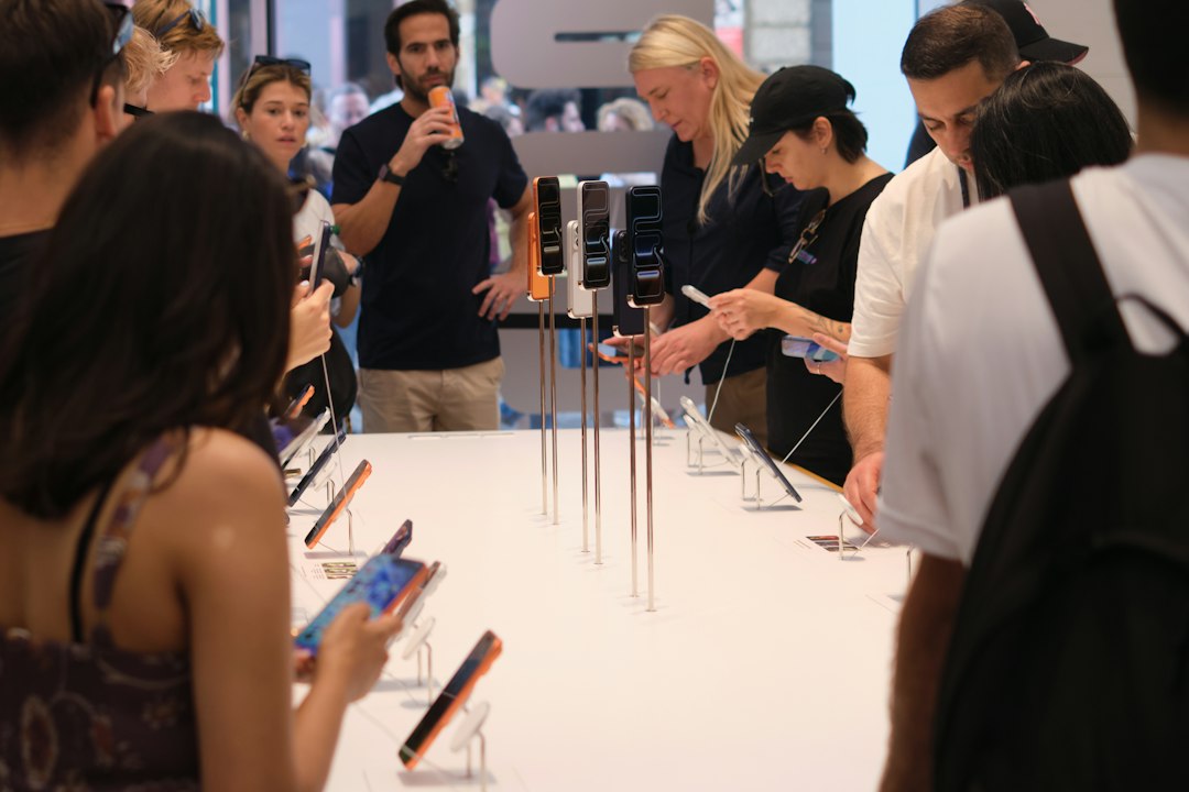 People examining smartphones displayed on a table
