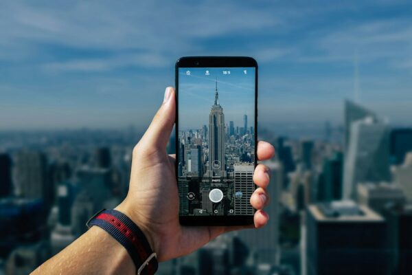 Person taking photo of gray tower