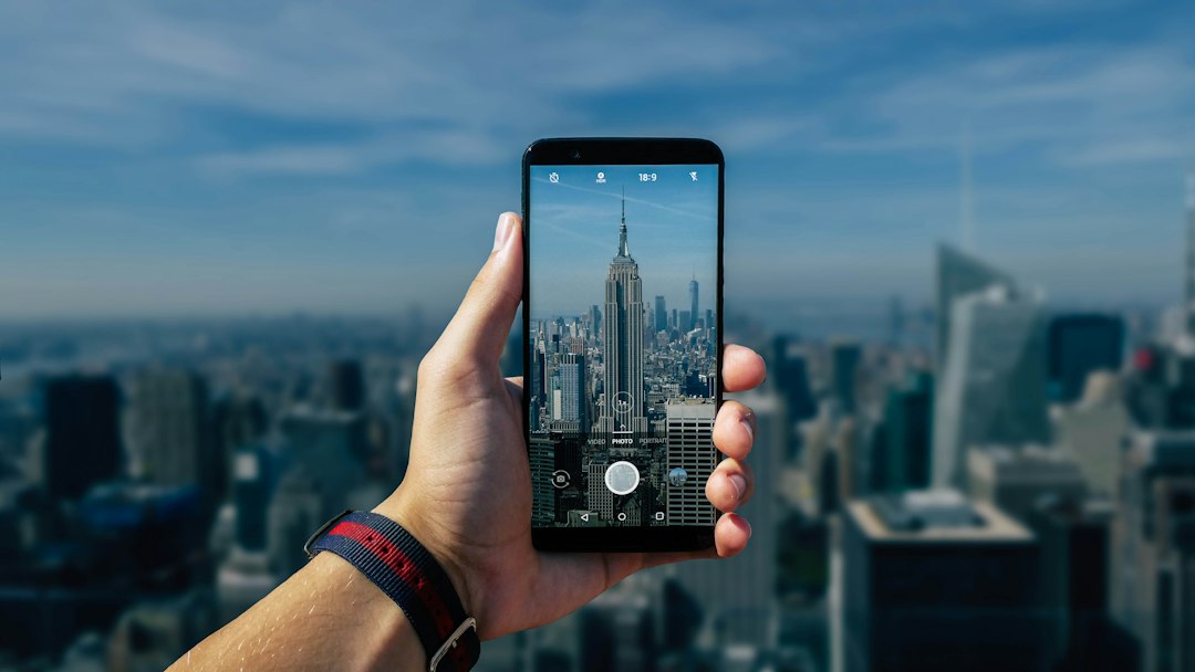 Person taking photo of gray tower