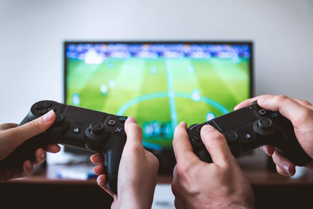 Two people playing Sony PS4 game console