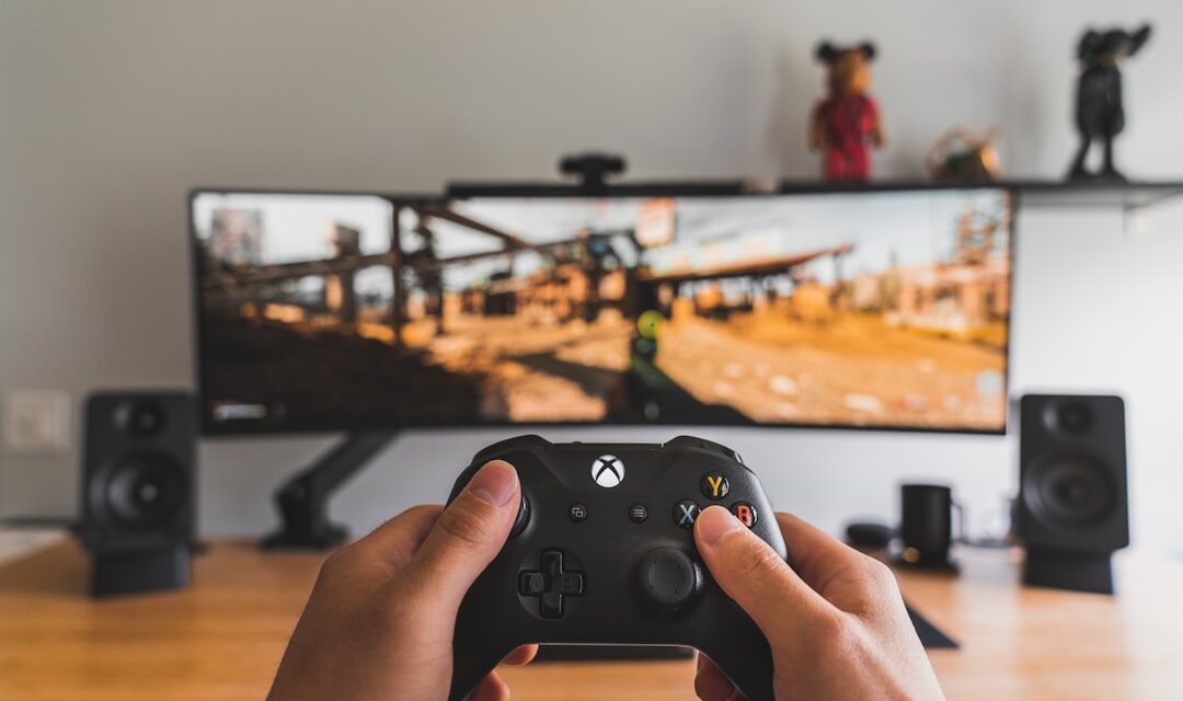 Person holding black game controller