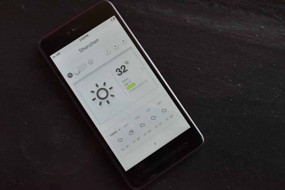 A cell phone with a weather station on the screen