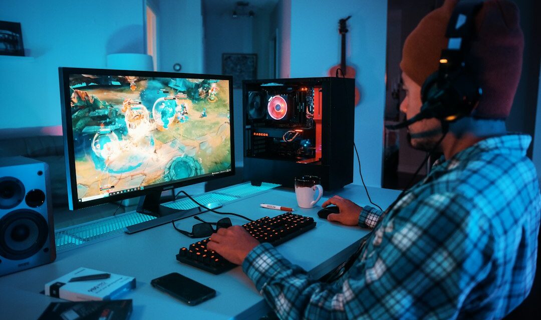 A person wearing headphones and using a computer