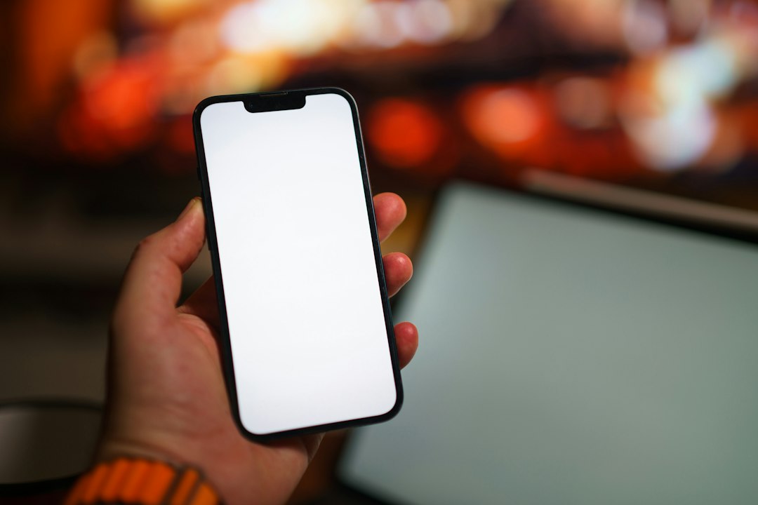 A person holding a cell phone in their hand