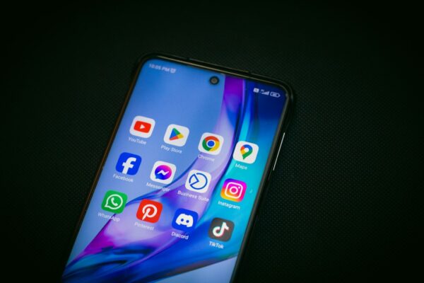 A close up of a cell phone on a black surface