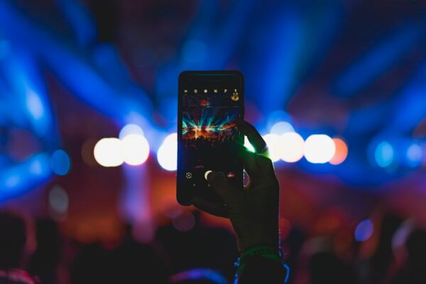 Person taking photo of live concert