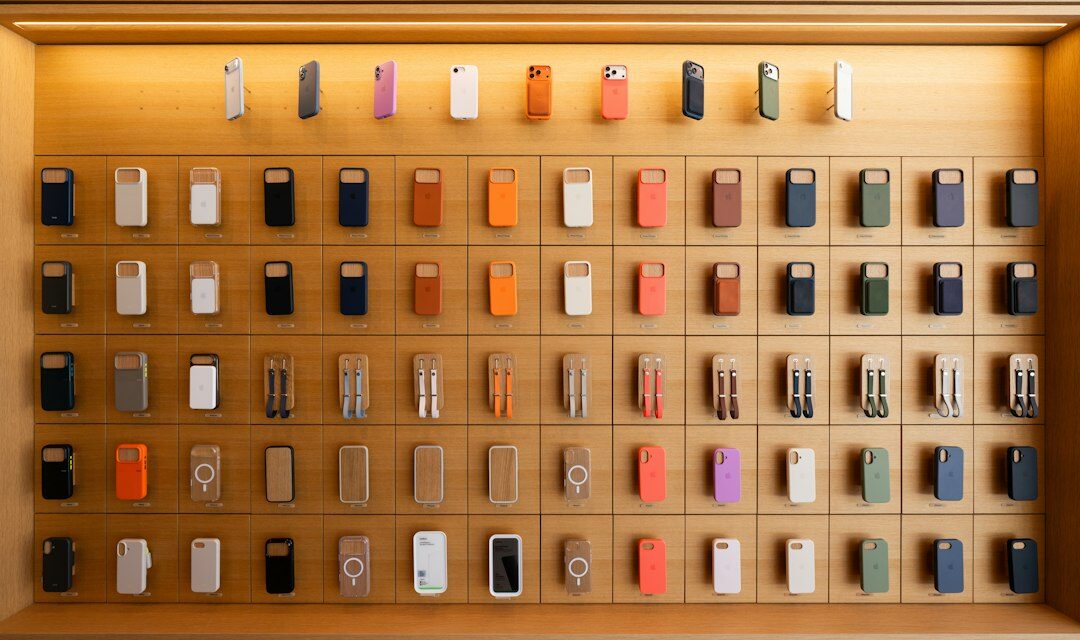 Colorful electronic devices displayed on a wooden shelf