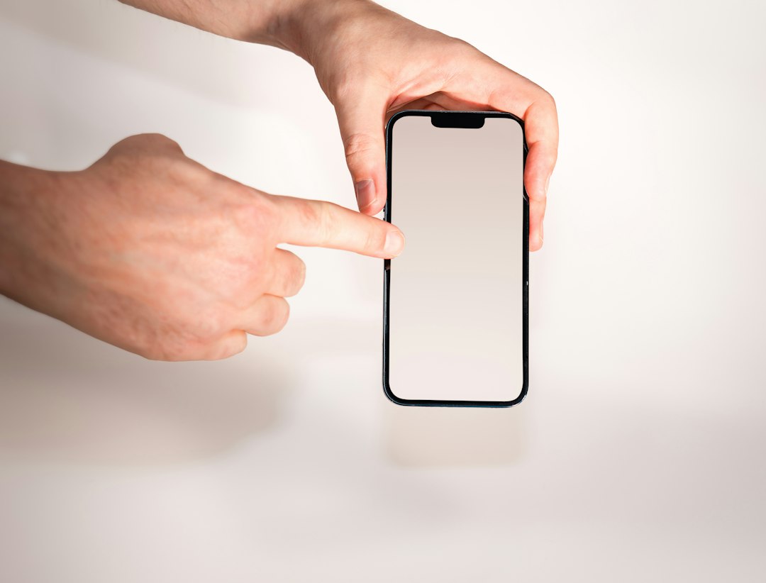 A person holding a cell phone in their hand