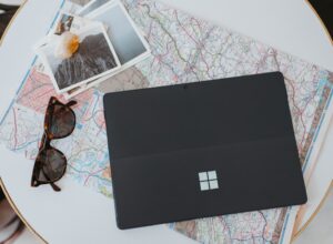 A laptop computer sitting on top of a white table