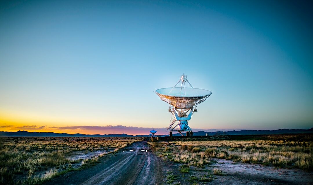 White radar telescope on grass field