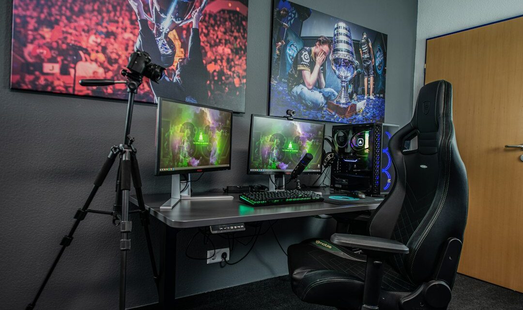 Black flat screen computer monitor on black wooden desk