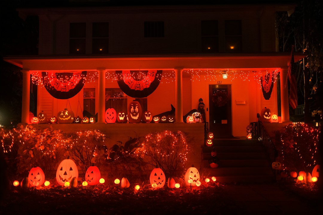 House decorated for halloween with orange lights and pumpkins