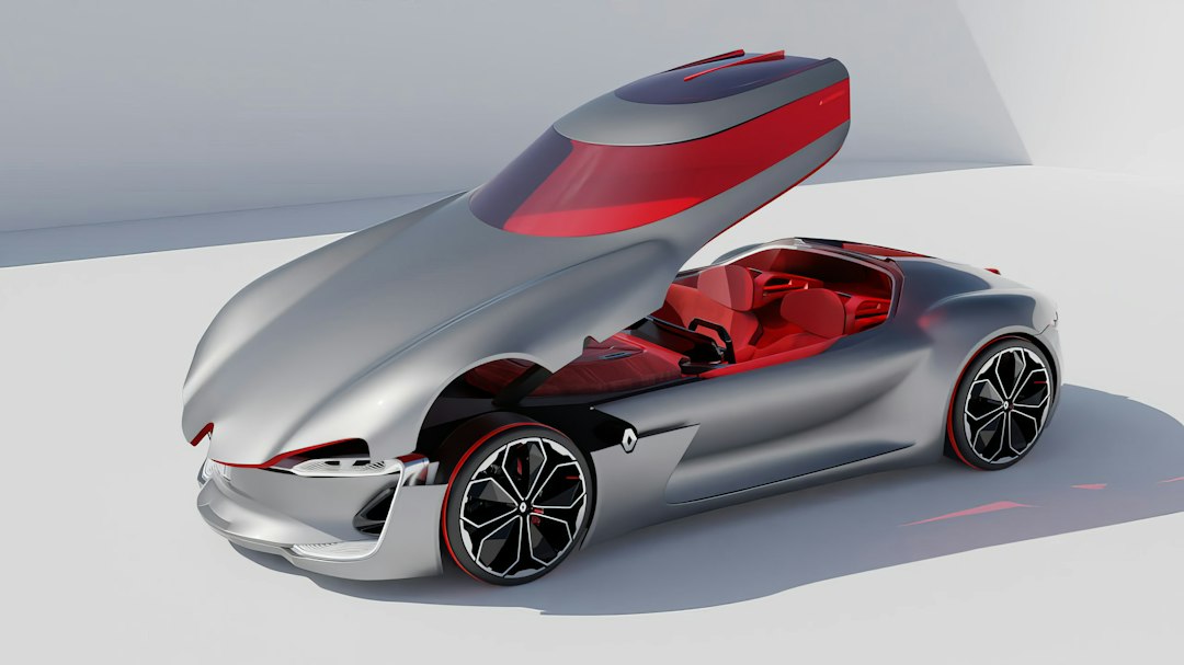 A silver car with a red interior on a white surface