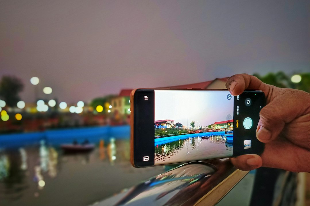 A person taking a picture with a cell phone