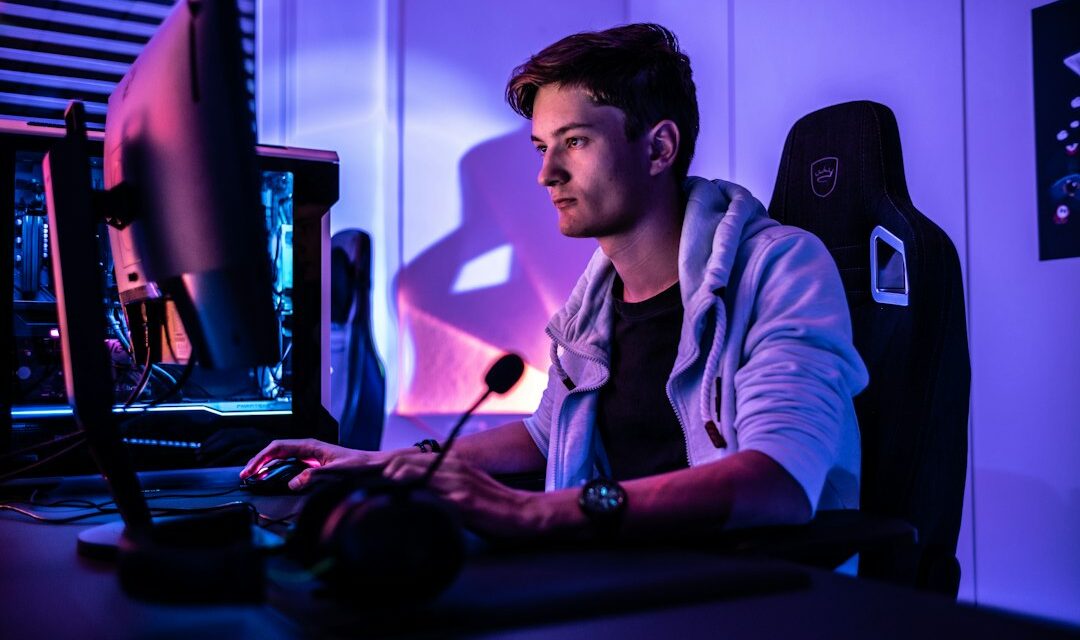 A man sitting in front of a computer monitor